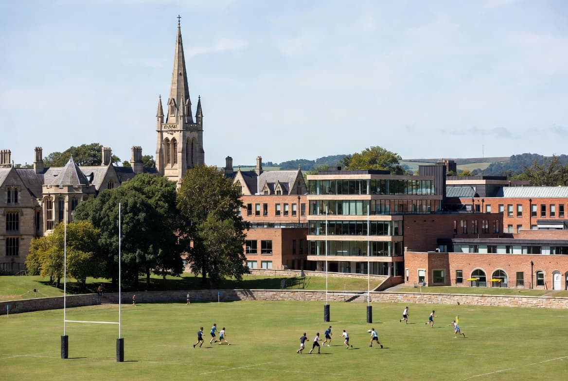 Sports fields with historic and modern campus buildings